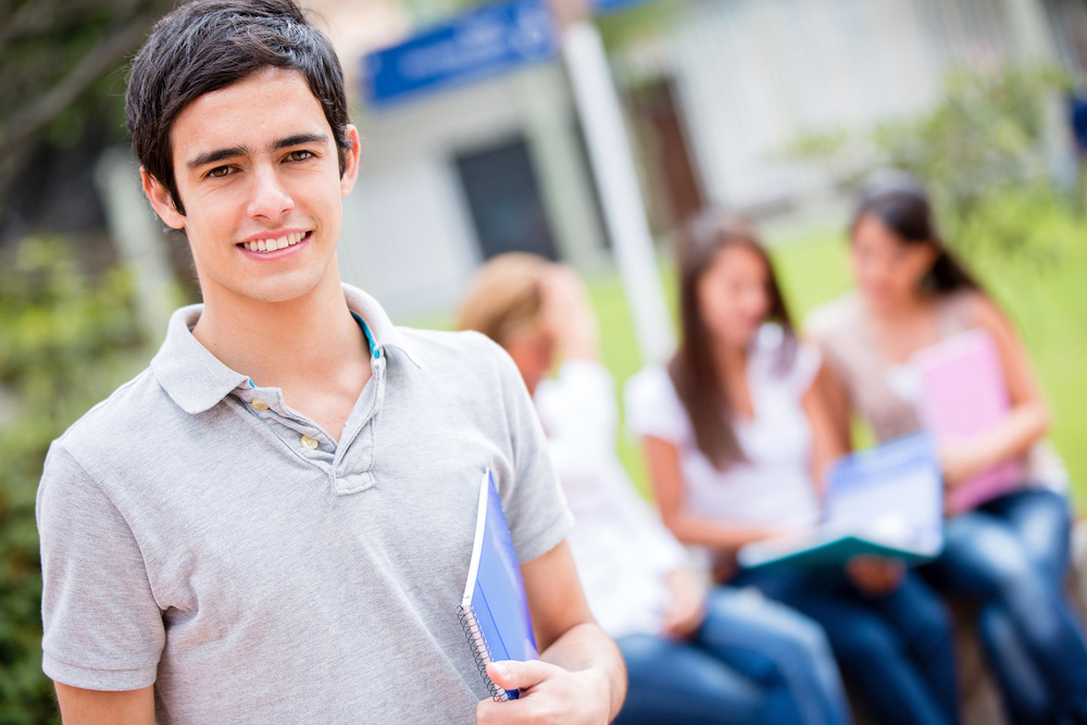 Casual male student at college looking happy