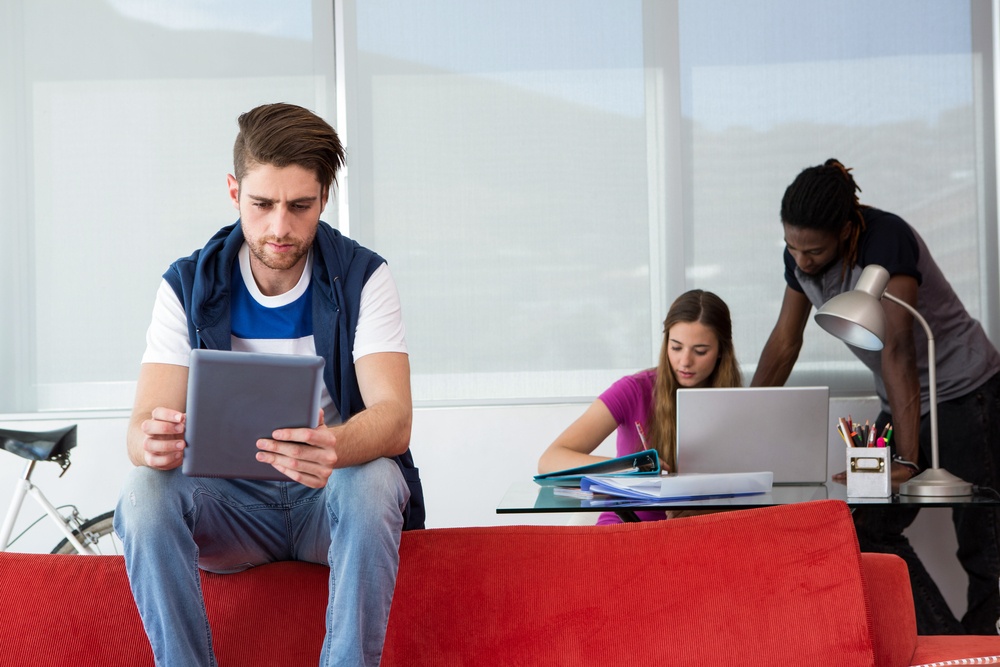 Creative team with digital tablet and laptop in office