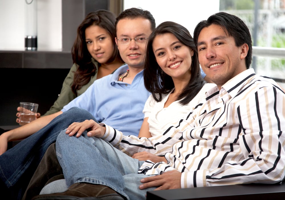 group of happy friends smiling at their home